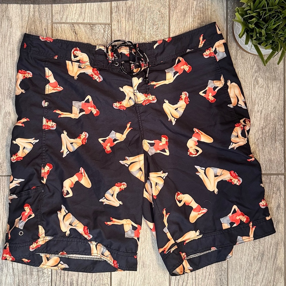 Sinister Men's Black Swim Board Shorts with Pin-Up Print & Pockets